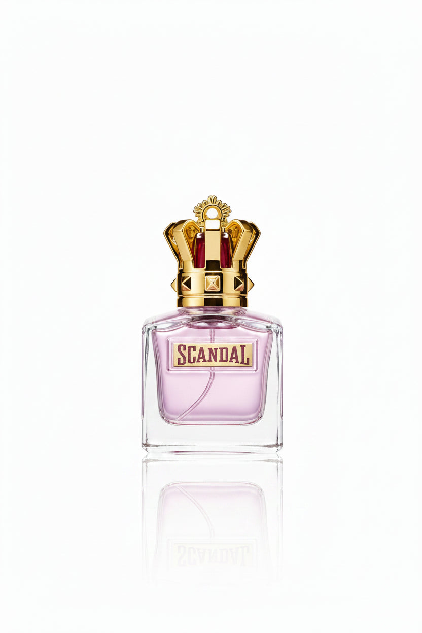 A hand with black fingernails holds a bottle of Scandal perfume by Cartier, which features a clear glass body with pink liquid and a prominent gold crown cap. Other identical perfume bottles are lined up in the background on a gold and white display stand.