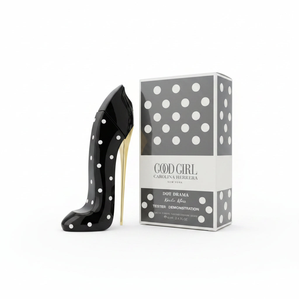 A black high-heeled shoe-shaped perfume bottle with white polka dots stands on a mirrored tray next to its product box labeled 'GOOD GIRL' by Carolina Herrera.
