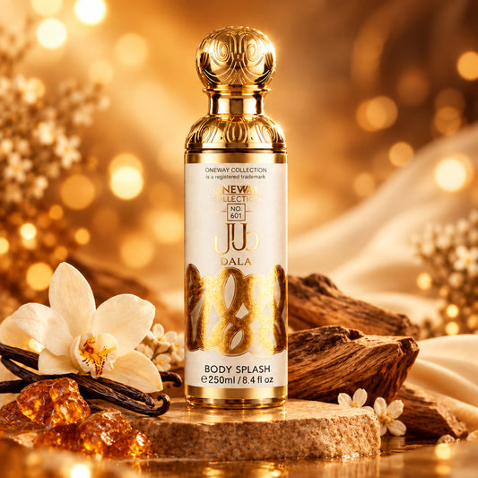 A bottle of Ju Dala One Way Collection Body Splash in the No. 230 edition, featuring a metallic gold cap and gold lettering on a white label, set against a dark gray and white marble background.