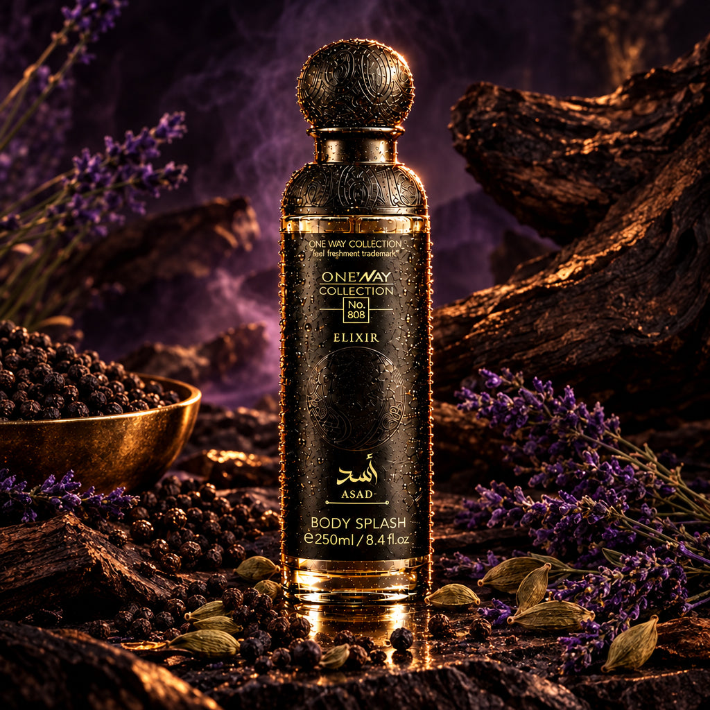 A bottle of One Way Collection Elixir Body Splash in a dark metallic black finish with a matching spherical cap, shown on a dark reflective surface with coffee beans scattered around it.