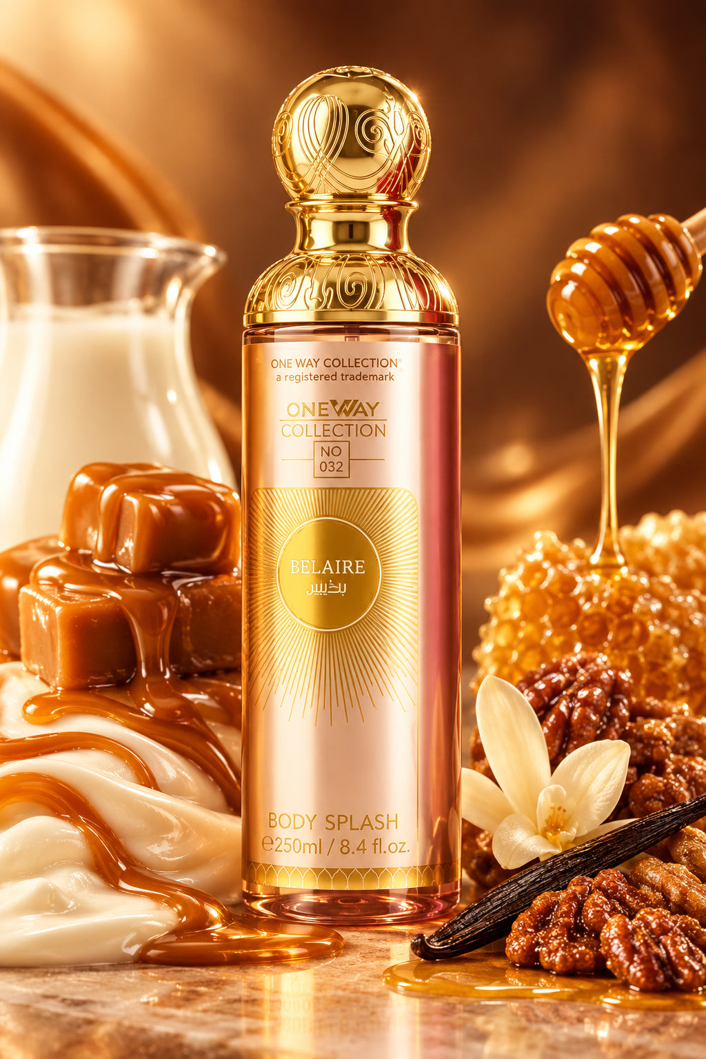 A bottle of One Way Collection body splash in the 'Rocade Joy' scent, featuring a metallic pink bottle with a gold cap and gold label, set against a light marble background with pink rose petals at the base.